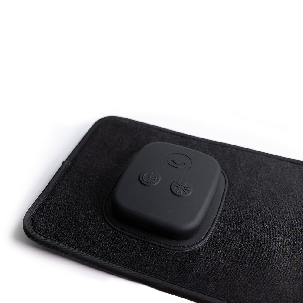 Fringe Red Light Therapy Wrap features a black control unit with three illuminated buttons on a dark fabric wrap.