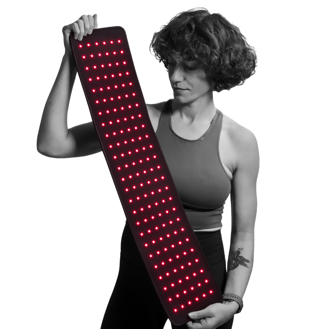 Fringe extra-long red light therapy wrap with active red LEDs held by a woman.