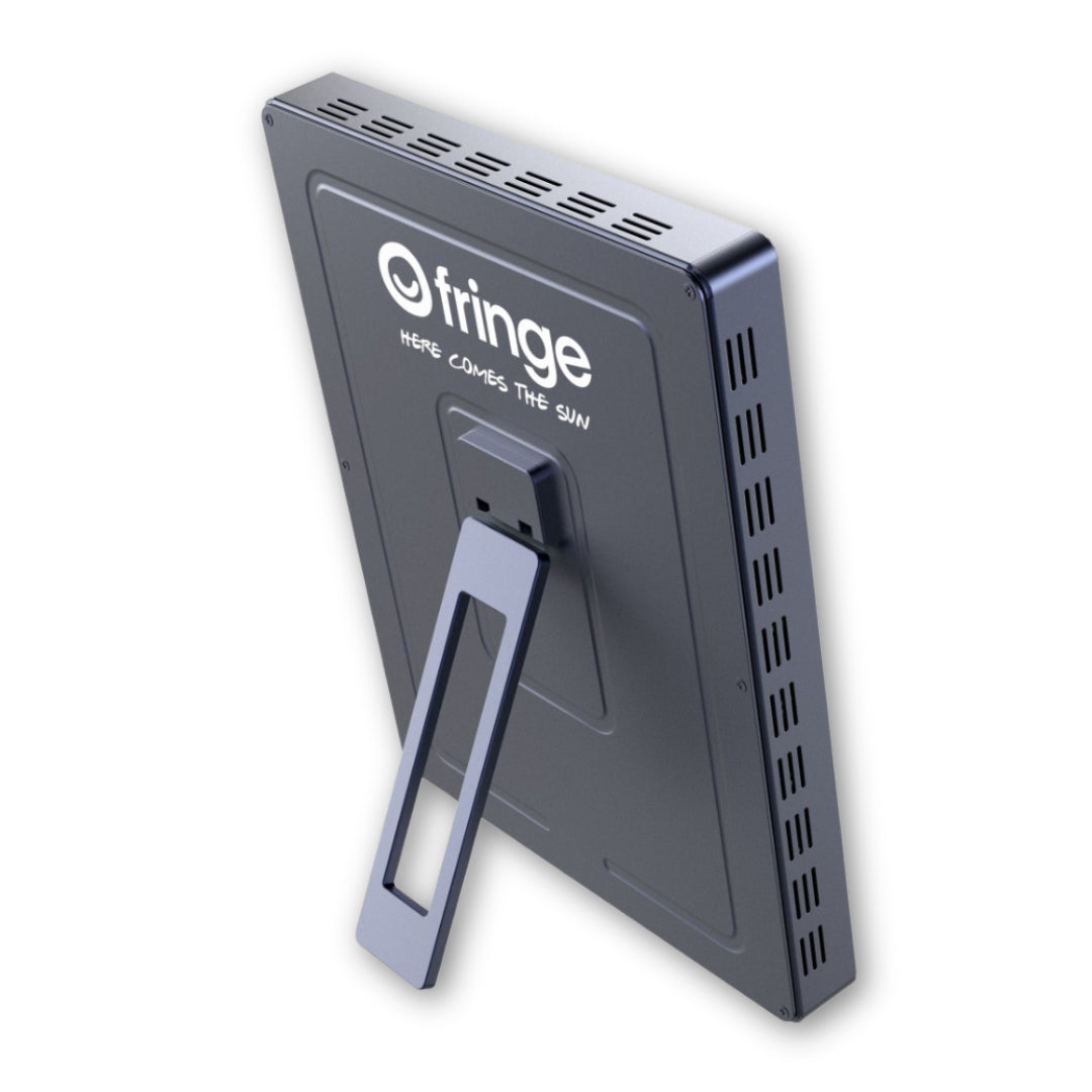 Fringe red light therapy panel with a kickstand, displaying the Fringe logo and "HERE COMES THE SUN".